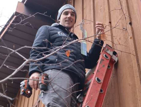 Technician Installing a Bird Flasher Deterrent Technician Installing a Bird Flasher Deterrent